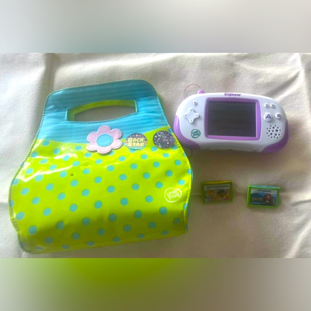 Leapster Explorer with two games and a purse for storage.